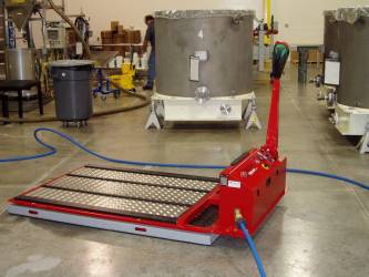Air Bearings reduce the friction under this tote so that it can be positioned omni-directional by use of a low-profile drive unit. This unit is one of many Air Film Transporters built by Solving.